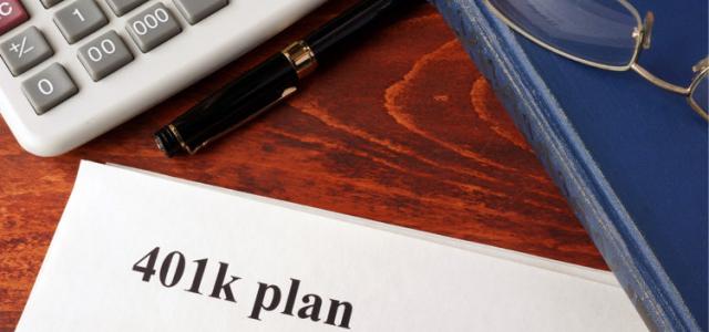401k plan paper with a calculator and a book next to it