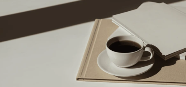 a coffee cup with notebooks